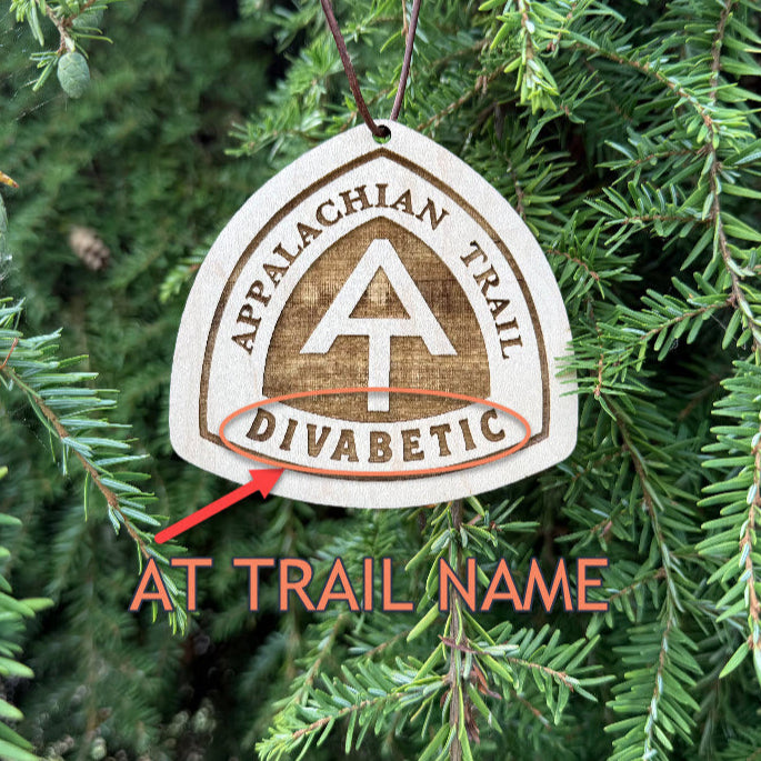 Personalized Appalachian Trail wooden name tag with custom engraving, Appalachian Trail custom backpack tag for thru-hikers, Custom engraved Appalachian Trail wooden tag photographed on hiking gear, Eco-friendly Appalachian Trail personalized tag gift for hikers, Appalachian Trail custom wooden ornament with engraved trail name, Handmade Appalachian Trail trail name tag made from reclaimed wood, Laser engraved Appalachian Trail backpack tag with trail name