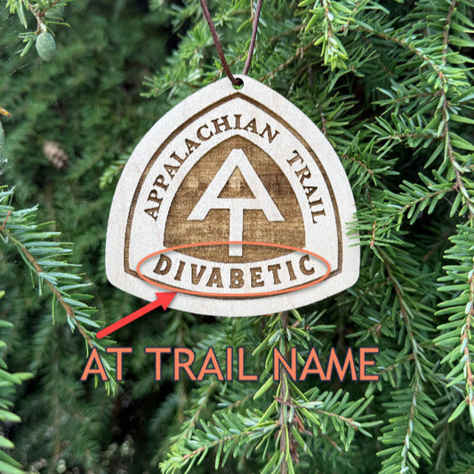 Personalized Appalachian Trail wooden name tag with custom engraving, Appalachian Trail custom backpack tag for thru-hikers, Custom engraved Appalachian Trail wooden tag photographed on hiking gear, Eco-friendly Appalachian Trail personalized tag gift for hikers, Appalachian Trail custom wooden ornament with engraved trail name, Handmade Appalachian Trail trail name tag made from reclaimed wood, Laser engraved Appalachian Trail backpack tag with trail name