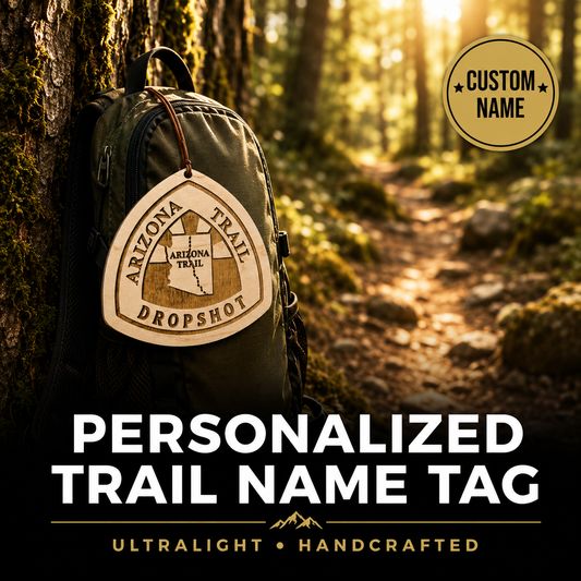 Backpack with a personalized trail name tag in a forest setting