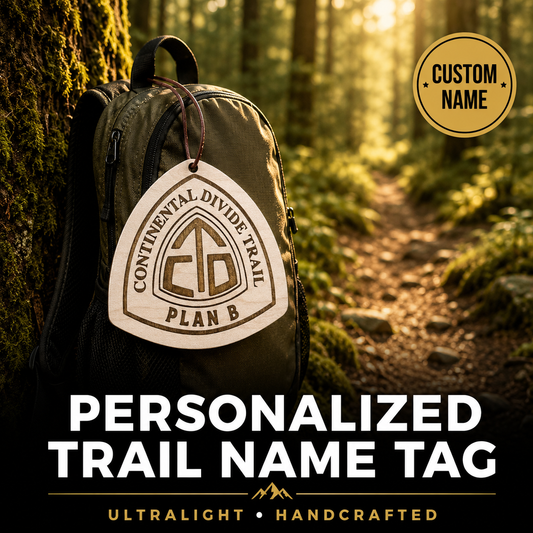 Backpack with a personalized trail name tag in a forest setting