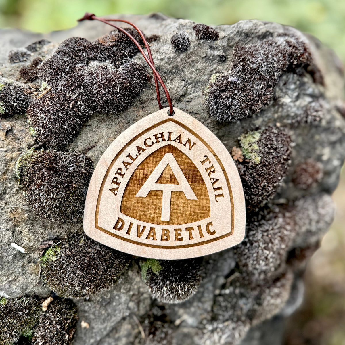 Appalachian Trail wooden hangtag displayed on natural stone outdoors