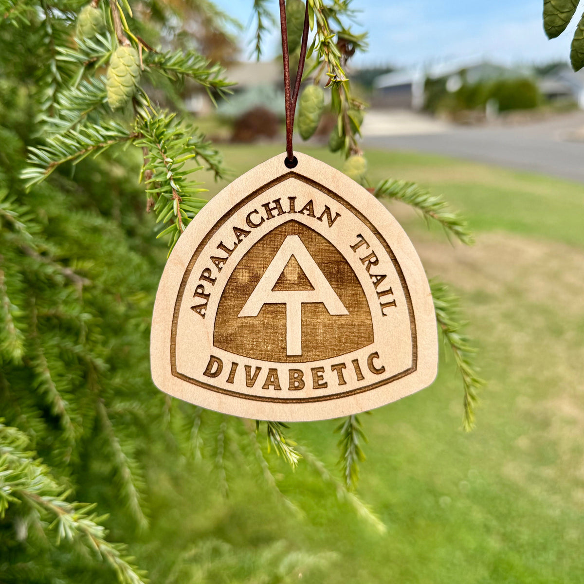 Personalized Appalachian Trail wooden hangtag hanging outdoors in a grassy setting