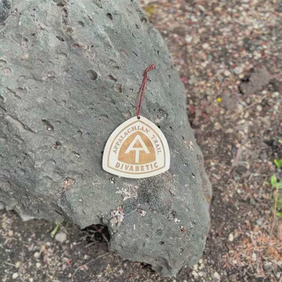 Personalized Appalachian Trail wooden name tag with custom engraving, Appalachian Trail custom backpack tag for thru-hikers, Custom engraved Appalachian Trail wooden tag photographed on hiking gear, Eco-friendly Appalachian Trail personalized tag gift for hikers, Appalachian Trail custom wooden ornament with engraved trail name, Handmade Appalachian Trail trail name tag made from reclaimed wood, Laser engraved Appalachian Trail backpack tag with trail name